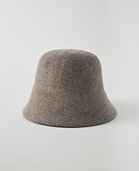 A fuzzy, taupe bucket hat sits centered on a plain, light gray background. carousel Product Image 1