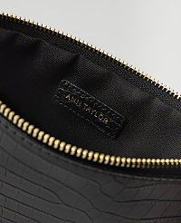 A black, crocodile-embossed clutch with a gold zipper is open to reveal a black interior with an "ANN TAYLOR" logo. carousel Product Image 2