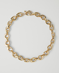 A chunky gold chain necklace with a toggle clasp rests on a plain white background. carousel Product Image 1