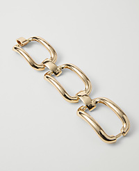 A gold chain with three interlocking, elongated rectangular links lies on a plain white background. carousel Product Image 1