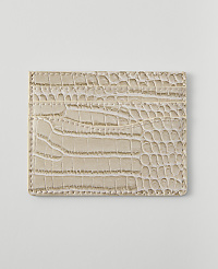 A light beige, crocodile-embossed cardholder with multiple slots rests on a plain white background. carousel Product Image 2