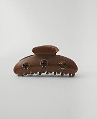 A brown claw clip with three amber-colored stones is centered against a plain, light gray background. carousel Product Image 1