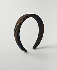 A brown and blue plaid headband rests on a plain white background. carousel Product Image 1