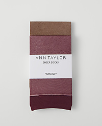 A pack of three Ann Taylor sheer socks in varying shades of brown and pink is laid flat against a plain white background. carousel Product Image 1