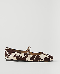 A cow-print Mary Jane flat shoe rests on a plain white background. carousel Product Image 2