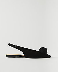 A black slingback flat with a rose embellishment sits against a plain white background. carousel Product Image 1