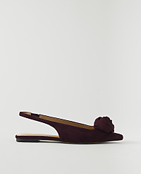 A deep red suede slingback flat with a floral embellishment rests on a plain white background. carousel Product Image 1