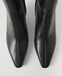 A pair of sleek black leather boots with pointed toes are presented against a plain white background. carousel Product Image 2