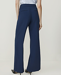 A person wearing navy blue wide-leg trousers and black heels stands against a plain, light-colored background. carousel Product Image 3
