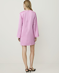 A woman in a pink dress stands against a plain white background. carousel Product Image 2
