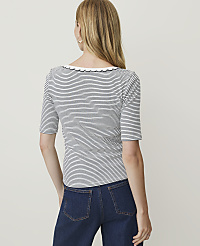 A woman in a striped shirt and jeans stands against a plain white background. carousel Product Image 2