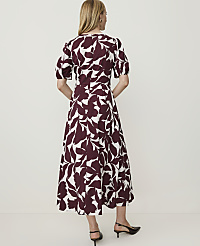 A woman in a white and burgundy floral dress stands against a plain white background. carousel Product Image 2