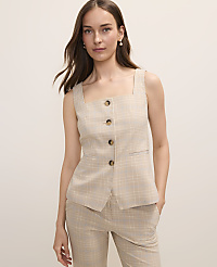 A woman in a plaid vest and pants stands against a plain, light-colored background. carousel Product Image 1