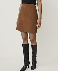 A woman in a brown corduroy skirt and black knee-high boots stands against a plain white background. carousel Product Image 2
