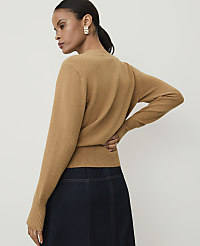 A woman in a camel-colored sweater and dark denim skirt stands against a plain white background. carousel Product Image 2
