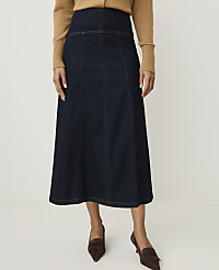 A woman in a dark denim skirt and brown sweater stands against a plain white background. carousel Product Image 2
