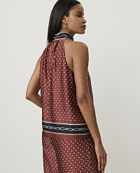 A woman in a patterned rust-colored top and pants stands against a plain white background. carousel Product Image 2