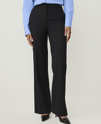 A person in a blue striped shirt and black flared trousers stands against a plain white background. carousel Product Image 1