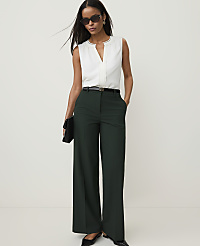 A woman in a white sleeveless blouse and dark green wide-leg pants stands against a plain white background. carousel Product Image 4