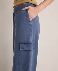 A hand rests in the pocket of blue cargo pants against a neutral background. carousel Product Image 2