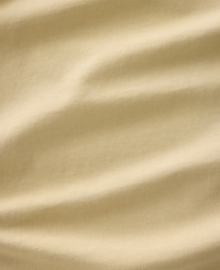 Soft, rippling folds of a light tan fabric fill the frame, creating a textured and abstract background. carousel Product Image 5