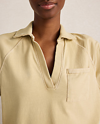 A close-up of a woman wearing a light yellow collared shirt with a pocket, against a plain, light background. carousel Product Image 2