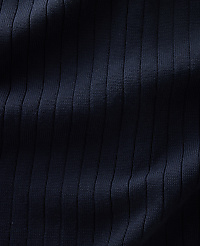 A close-up view of dark navy ribbed fabric fills the frame, with subtle shadows highlighting the vertical texture. carousel Product Image 5