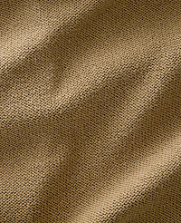 A close-up view of a textured, tan knitted fabric fills the frame, with soft shadows and highlights creating depth across its surface. carousel Product Image 4