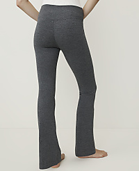 A person's legs in dark gray flared leggings are shown against a plain white background. carousel Product Image 2