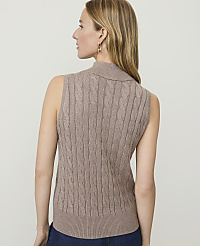 A woman in a cable-knit sleeveless turtleneck stands against a plain, light-colored background. carousel Product Image 2