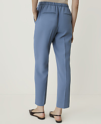 A person wearing blue trousers and black flats stands against a plain white background. carousel Product Image 3