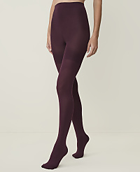 A person models burgundy tights against a plain, light-colored background. carousel Product Image 1