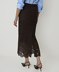 A person wearing a brown lace skirt and a blue shirt stands against a plain white background. carousel Product Image 3