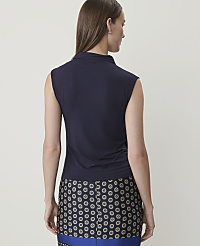 A woman in a navy sleeveless top and a patterned skirt stands against a plain white background. carousel Product Image 2