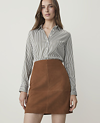 A woman in a striped shirt and brown suede skirt stands against a plain white background. carousel Product Image 1