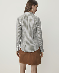A woman in a striped shirt and brown skirt stands against a plain white background. carousel Product Image 2