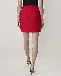 A woman in a red tweed skirt and black heels walks away from the camera against a plain white background. carousel Product Image 4