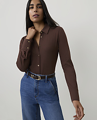 A woman in a brown button-up shirt and blue jeans stands against a plain white background. carousel Product Image 1