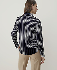 A woman in a black and white striped blouse and tan pants stands against a plain, light background. carousel Product Image 2