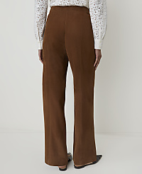 A person wearing brown corduroy pants and a white lace-trimmed shirt stands against a plain white background. carousel Product Image 3
