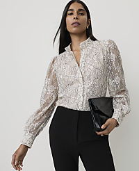 A woman in a lace blouse and black pants holds a black clutch against a plain background. carousel Product Image 1