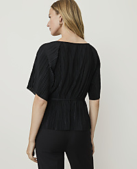 A woman in a black pleated top and pants stands against a plain white background. carousel Product Image 2