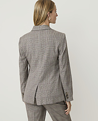 A woman in a plaid blazer and pants stands against a plain, light-colored background. carousel Product Image 2