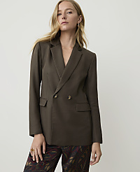 A woman in a dark brown double-breasted blazer and patterned pants stands against a plain white background. carousel Product Image 1