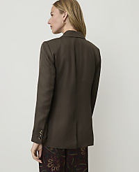 A woman in a brown blazer and patterned pants stands against a plain, light-colored background. carousel Product Image 2