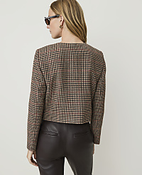 A woman in a plaid jacket and leather pants stands against a plain background. carousel Product Image 2
