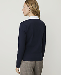 A woman in a navy sweater and plaid pants stands against a plain white background. carousel Product Image 2