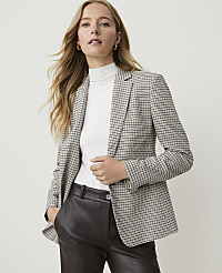 A woman in a checkered blazer and dark pants stands against a plain, light background. carousel Product Image 2