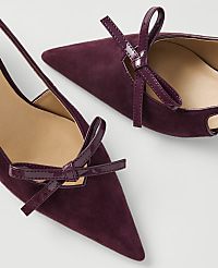 Two plum-colored suede kitten heels with patent leather bows are arranged on a white background. carousel Product Image 2