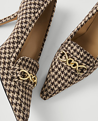 A pair of houndstooth patterned loafers with gold chain accents are displayed against a plain white background. carousel Product Image 2